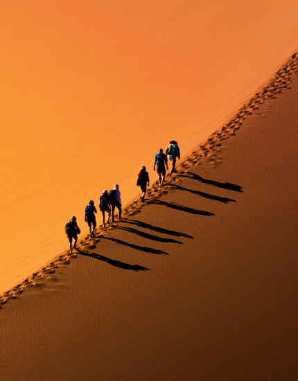 Hikers on a desert dune in Oman