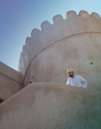Hikers on a desert dune in Oman